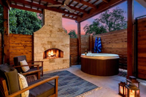 An Enchanted Hideaway outdoor fireplace hot tub